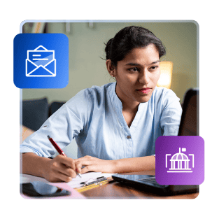A female international student sits at a desk with paper and a pen. She is framed by illustrated images of an open envelope with a letter poking out, and a college building with a flag on top.