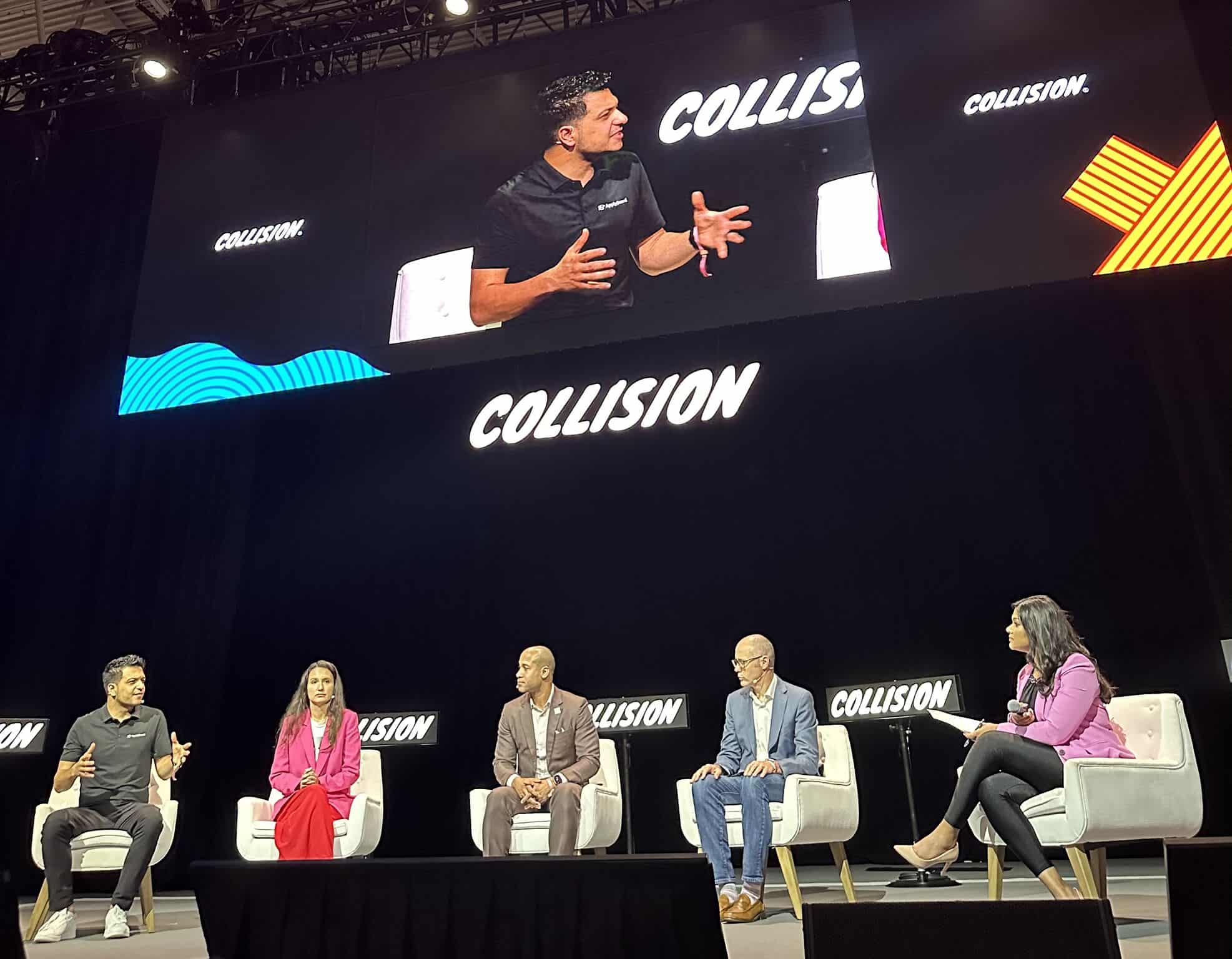 Onstage panel discussion including Meti Basiri, Iryna Volnytska, Michael Ellison, Tom Simon, and moderator Emily Ragobeer