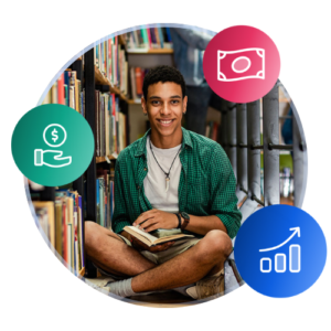An international student sits crosslegged in a library, holding a book open and smiling