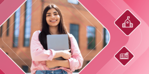 Smiling international student stands in front of a building holding a laptop