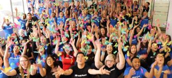 ApplyBoard employees with arms raised