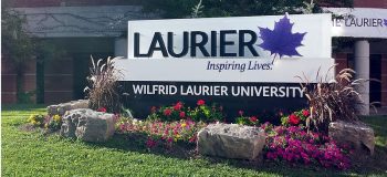 The main Wilfrid Laurier University campus sign in Waterloo, Ontario