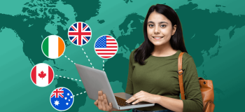 A female student holding a laptop with five different country's flags around her.