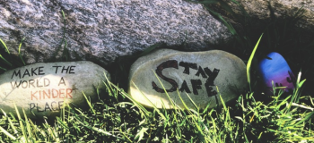 Rocks with "Make the world a kinder place" and "Stay safe" written on them