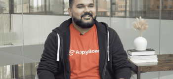 Ankit Agarwal sitting on a chair at Canada HQ during his Core Values in Action: Making Work Fun interview.