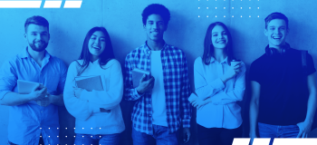 A photo of a group of students standing against a wall.