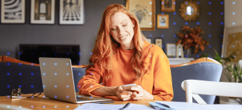 A photo of a woman at her desk.