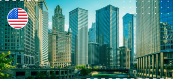 A photo of a city in the United States with an illustration of the US flag in the top left corner.